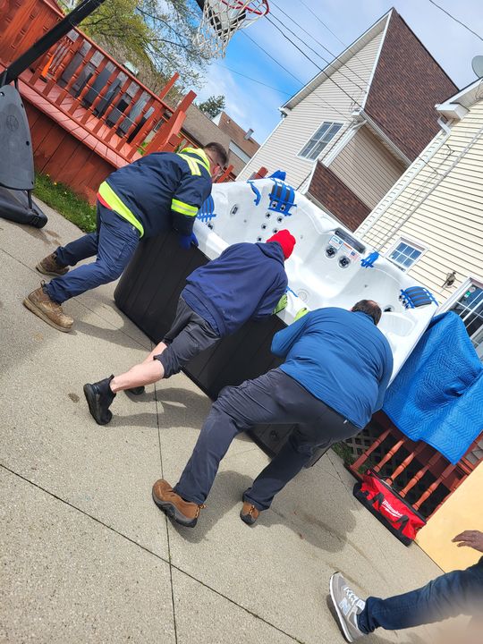 Crew moving a hot tub on a cart (Hot Tub Moving Services) by Affordable Moving Solutions of Ohio