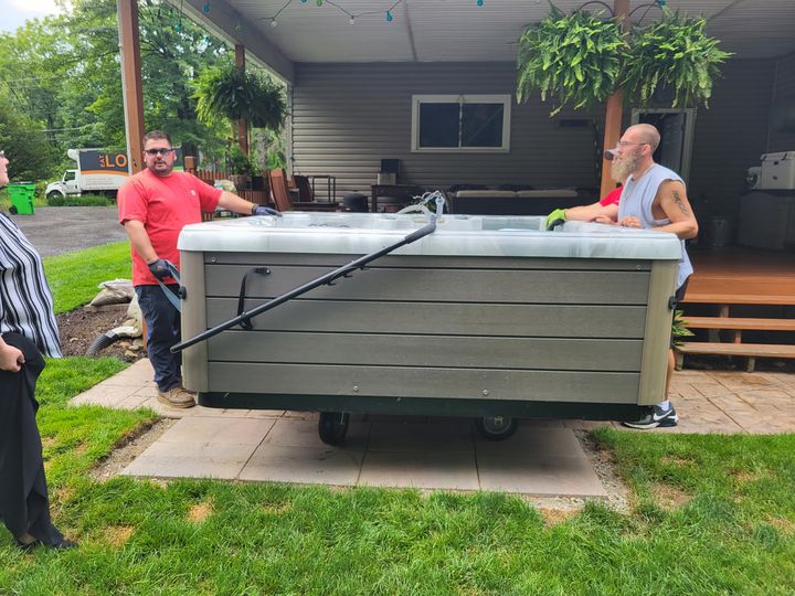 Crew positioning a hot tub on a patio (Hot Tub Moving) by Affordable Moving Solutions of Ohio